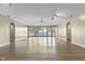 Open living area with light wood floors, and a wall of windows at 8560 N College Ave, Indianapolis, IN 46240
