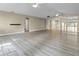 Open concept living room features wood floors, multiple ceiling fans, and beige walls at 8560 N College Ave, Indianapolis, IN 46240