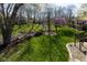 Expansive backyard with lush greenery, mature trees, and a fire pit area for outdoor enjoyment at 9789 Logan Ln, Fishers, IN 46037
