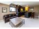 Basement bar featuring custom cabinetry, seating, and ample space for entertaining guests at 9789 Logan Ln, Fishers, IN 46037