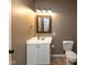 Neutrally decorated bathroom with a mirror, vanity, toilet, and modern fixtures at 9789 Logan Ln, Fishers, IN 46037