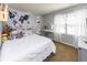 Cozy bedroom decorated with a world tapestry and furnished with a vanity and modern shelves by the window at 9789 Logan Ln, Fishers, IN 46037