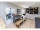 Open-concept dining area featuring a rustic table and bench seating, adjacent to the kitchen and living spaces at 9789 Logan Ln, Fishers, IN 46037