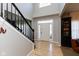 Welcoming entryway with hardwood floors and a staircase offers a grand entrance to this beautiful home at 9789 Logan Ln, Fishers, IN 46037