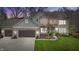Charming two-story home featuring a brick facade, attached garage, and manicured lawn at 9789 Logan Ln, Fishers, IN 46037