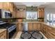 Well-lit kitchen featuring stainless steel appliances, granite countertops, and custom wood cabinetry at 9789 Logan Ln, Fishers, IN 46037
