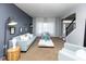 Stylish living room with a modern sofa, large windows, and elegant decor offers a serene and inviting space at 9789 Logan Ln, Fishers, IN 46037