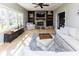 Cozy living room with ample natural light, featuring a brick fireplace, built-in shelves and neutral decor at 9789 Logan Ln, Fishers, IN 46037
