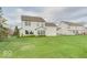 Well-maintained backyard showcasing a spacious lawn and the rear of the two-story home at 9844 Plantana Blvd, Fishers, IN 46038