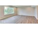 Spacious basement with large window offering natural light and laminate wood flooring throughout the room at 9844 Plantana Blvd, Fishers, IN 46038