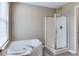 Bathroom featuring a soaking tub next to window and glass door walk-in shower at 9844 Plantana Blvd, Fishers, IN 46038