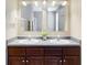 Bathroom vanity with double sinks, decorative faucet, and two large mirrors at 9844 Plantana Blvd, Fishers, IN 46038