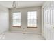 Bedroom with two windows, neutral carpet and paint and door to the side at 9844 Plantana Blvd, Fishers, IN 46038
