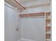 Walk-in closet with built-in shelving and metal rods for organized storage at 9844 Plantana Blvd, Fishers, IN 46038