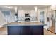 Modern kitchen has stainless appliances, white cabinets, and a large island for meal preparation at 9844 Plantana Blvd, Fishers, IN 46038