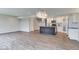 Open kitchen with stainless steel appliances, white cabinetry, island, and hardwood floors at 9844 Plantana Blvd, Fishers, IN 46038