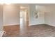 Bright living room with luxury vinyl plank flooring and views to other rooms and the upper floor at 9844 Plantana Blvd, Fishers, IN 46038