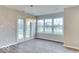 Bright living area boasts hardwood floors, modern lighting, and large windows overlooking backyard at 9844 Plantana Blvd, Fishers, IN 46038