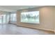 Spacious living room with hardwood floors, many windows offering a scenic view of the outdoors at 9844 Plantana Blvd, Fishers, IN 46038