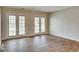 Bright living room with dual doors offering lots of natural light and luxury vinyl plank flooring at 9844 Plantana Blvd, Fishers, IN 46038