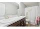 Bathroom with double sinks, modern fixtures, and shower with shower curtain at 9916 Gallop Ln, Fishers, IN 46040