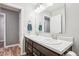 Bathroom featuring a double sink vanity with modern fixtures and a large mirror at 9916 Gallop Ln, Fishers, IN 46040