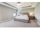 Spacious primary bedroom boasts neutral color palette, carpet, and a tray ceiling at 9916 Gallop Ln, Fishers, IN 46040