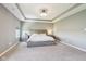 Spacious primary bedroom with a tray ceiling and neutral carpeting at 9916 Gallop Ln, Fishers, IN 46040