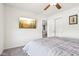 This carpeted bedroom features a ceiling fan, wall mounted television, and ensuite bath for a relaxing living space at 9916 Gallop Ln, Fishers, IN 46040