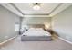 Bright primary bedroom features a tray ceiling and plush carpeting at 9916 Gallop Ln, Fishers, IN 46040