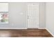 Bright entryway with hardwood floors and a six-panel white door at 9916 Gallop Ln, Fishers, IN 46040