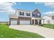 Beautiful two-story home with three car garage, front lawn, and brick and siding accents at 9916 Gallop Ln, Fishers, IN 46040