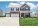 Charming two-story home featuring a three-car garage, brick accents, and a cozy front porch at 9916 Gallop Ln, Fishers, IN 46040