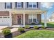 Inviting front porch with decorative wreath and seating, complementing the home's brick facade at 9916 Gallop Ln, Fishers, IN 46040