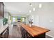 Bright kitchen with island, dining area, and view of the living room at 9916 Gallop Ln, Fishers, IN 46040