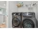 Laundry room with modern washer and dryer, plus storage shelf for supplies at 9916 Gallop Ln, Fishers, IN 46040
