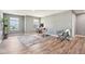 Spacious living room filled with natural light features hardwood flooring, gray walls, and a decorative area rug at 9916 Gallop Ln, Fishers, IN 46040