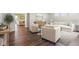 Spacious living room with neutral furniture, hardwood floors, and an open floor plan at 9916 Gallop Ln, Fishers, IN 46040