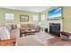 Inviting living room featuring a modern fireplace and ample seating on a large sectional at 9916 Gallop Ln, Fishers, IN 46040