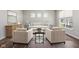 Open living room with neutral furniture, three windows and hardwood floors at 9916 Gallop Ln, Fishers, IN 46040