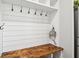 Mudroom featuring a built-in bench with storage hooks and shelving for organization at 9916 Gallop Ln, Fishers, IN 46040