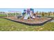 Community playground with swings, slides, play equipment, and a bordering pond at 9916 Gallop Ln, Fishers, IN 46040