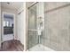 Sleek walk-in shower featuring stylish gray tile and glass doors, next to storage closet at 9916 Gallop Ln, Fishers, IN 46040