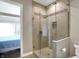 Bathroom featuring a walk-in shower with a glass door and a tiled surround at 1 Virginia Ave # 707, Indianapolis, IN 46204