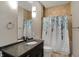Bathroom with a vanity, modern mirror, and a shower/tub combination with a stylish curtain at 1 Virginia Ave # 707, Indianapolis, IN 46204