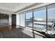 Bedroom featuring a large window with city views, hardwood floors, and modern design at 1 Virginia Ave # 707, Indianapolis, IN 46204