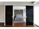 Bedroom featuring hardwood floors, gray rug, and dark sliding panel doors at 1 Virginia Ave # 707, Indianapolis, IN 46204