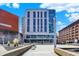 This building features a unique facade with a mix of glass and concrete, set against a beautiful blue sky at 1 Virginia Ave # 707, Indianapolis, IN 46204