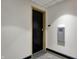 A black door is featured with a carpeted floor and an adjacent gray metal box at 1 Virginia Ave # 707, Indianapolis, IN 46204
