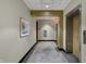 Hallway with neutral walls, carpet, an elevator door on the right, and art on the wall at 1 Virginia Ave # 707, Indianapolis, IN 46204